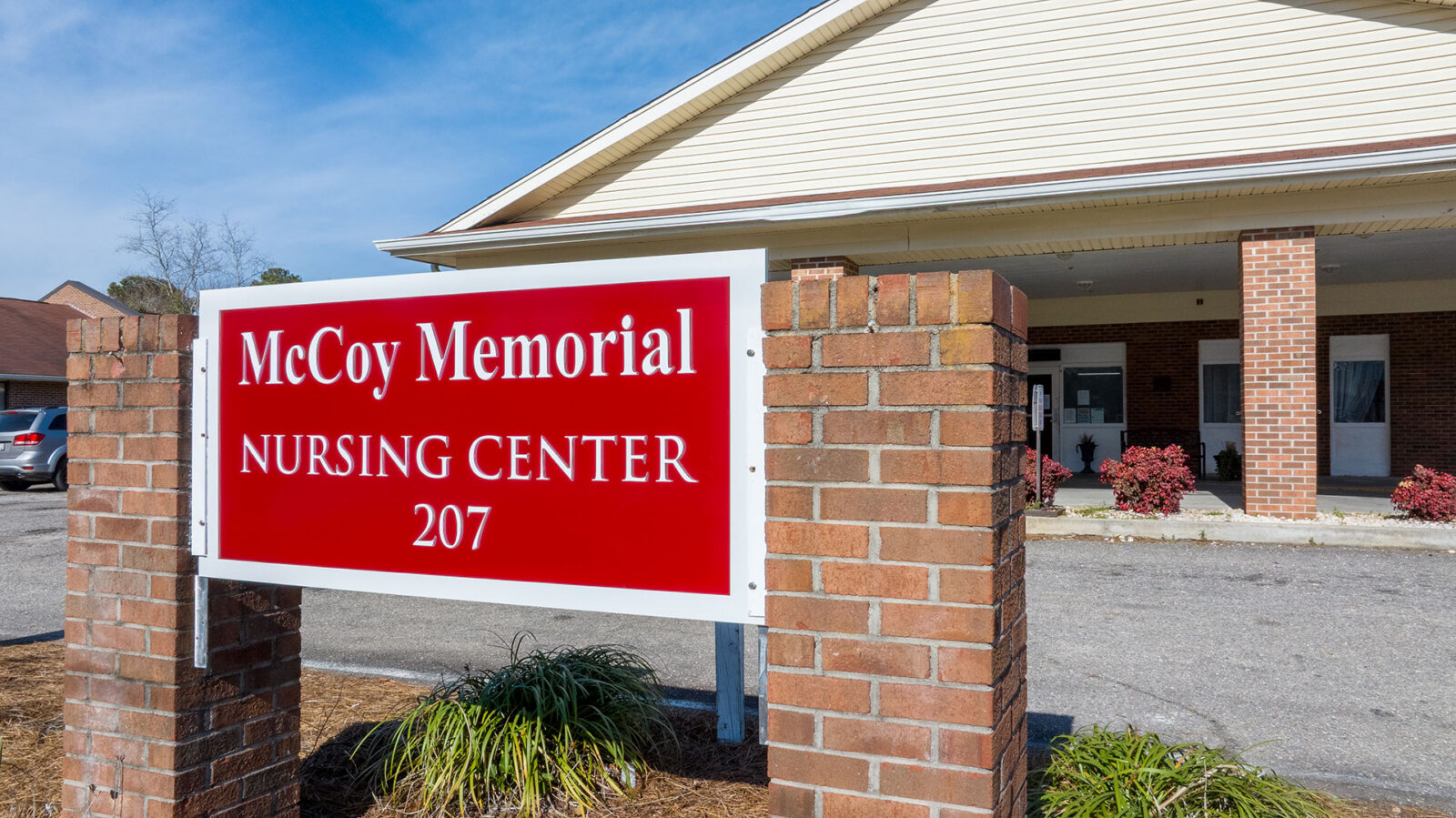 Sign for McCoy Memorial Nursing Center, building entrance visible.