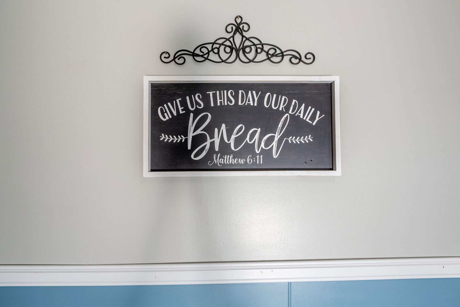 Sign with biblical phrase about daily bread.